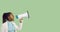 Young black woman shouting through megaphone on green copy space banner background