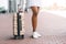 Young black woman with suitcase waiting taxi at airport