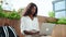 Young black woman university student learning online using laptop outdoor.