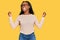 Young black woman wearing casual clothes and glasses very happy and excited doing winner gesture with arms raised, smiling and