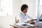 Young black woman working at computer in an office, close up