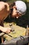 Young blacksmith hammering hot iron