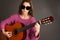 Young blind woman playing guitar