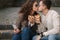 Young bloggers make selfie with slice of pizza in hands. Beautiful couple in sunglasses smile and kiss. Vegan fast food