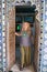 Young blond adult woman tourist walks through an intricate doorway while touring the City Palace