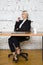 Young blond beauty businesswoman sitting at a office table with laptop, notebook and glasses in suit. Business concept.