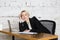 Young blond beauty businesswoman sitting at a office table with laptop, notebook and glasses in suit. Business concept.