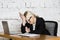 Young blond beauty businesswoman sitting at a office table with laptop, notebook and glasses in suit. Business concept.