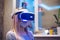 A young blond caucasian sick girl covers her face and wears a Virtual Reality Headset enjoys virtual reality in her