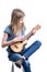 Young, blond girl in blue T-shirt is sitting and playing concert on ukulele instrument