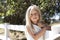 Young Blond Girl on Fence