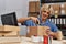 Young blond man ecommerce business worker unpacking cardboard box at office