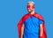 Young blond man wearing super hero custome looking away to side with smile on face, natural expression
