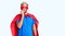 Young blond man wearing super hero custome looking stressed and nervous with hands on mouth biting nails