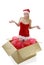 Young blond santa girl jumping out of the box