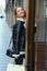 young blond slavic woman with long hair in black leather jacket on shopping closeup photo