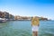 Young blond woman in big hat enjoying the beautiful views of the port of Chania