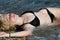 young blond woman in bikini, lie down