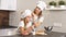 Young blond woman and child before baking cake