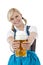 Young blond woman in dirndl toasts with beer stein