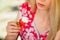 Young blond woman eating strawberries smiling in the garden summer sunny day, warm summer toning image, self care and healthy life