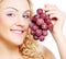 Young blond woman with grape