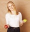 Young blond woman with green and red apple, good