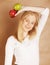 Young blond woman with green and red apple, good