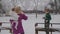 Young blond woman with her kids enjoying in snow park