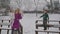 Young blond woman with her kids enjoying in snow park