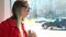 Young blond woman sitting in tram, day dreaming