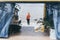 Young blond woman standing next to camper van overlooking the sea