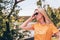 Young blond woman in sunglasses and yallow t-shirt posing on a sunny day outdoors