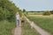 Young blond woman walking away from the camera with her two dogs