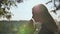 A young blonde 18 year old girl prays with folded hands.