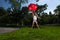 Young Blonde Athletic woman holding a Red Umbrella