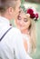 Young blonde bride closes her eyes enjoying groom`s kiss