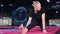 Young blonde caucasian male stretching and warming up before acrobatic training on trampoline