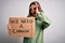 Young blonde girl holding protest banner for political problems and planet activism with happy face smiling doing ok sign with