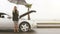 A young blonde girl stands beside her broken car under the umbrella