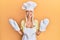 Young blonde girl wearing baker uniform and cook hat winking looking at the camera with sexy expression, cheerful and happy face