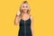 Young blonde girl wearing elegant and sexy look smiling happy and positive, thumb up doing excellent and approval sign
