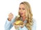 Young Blonde Haired Woman Eating a Hot Baked Jacket Potato with Cheddar Cheese