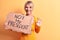 Young blonde woman asking for democracy holding banner with not my president message doing ok sign with fingers, smiling friendly