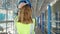 Young blonde woman builder wearing hardhat standing backwards at street