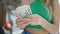 Young blonde woman counting israel shekels banknotes at street