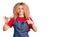 Young blonde woman with curly hair wearing barber apron pointing finger to one self smiling happy and proud