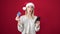 Young blonde woman doing christmas online shopping over isolated red background