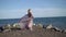 Young blonde woman in dress near sea