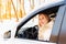 Young blonde woman driver sit in her white car and smile happy. Insurance, safety, rent a car